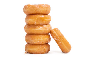 donuts with icing sugar stacked on stock white background