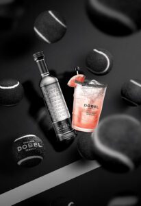 Maestro Dobel Diamante Tequila Bottle and an Ace Paloma in a 2024 US Open Branded Souvenir Cup