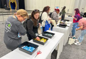 Attendees customize tote bags with patches